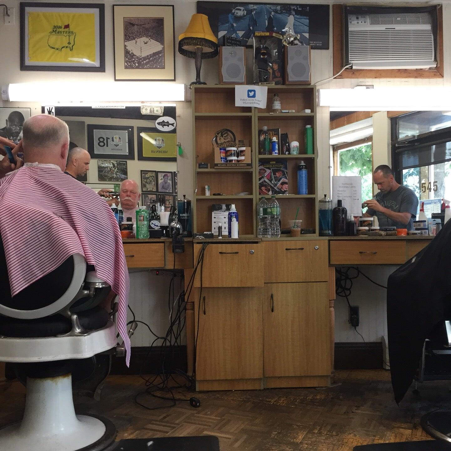 An original photograph inside Lessard’s, showing barber chairs, mirrors and the shop at work